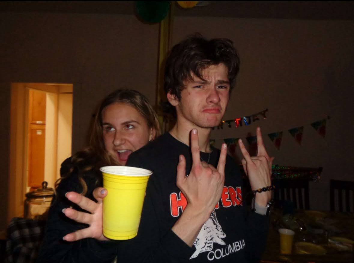 A banner image showcasing Max and his friend Ella, The image inverts colors as you hover over it